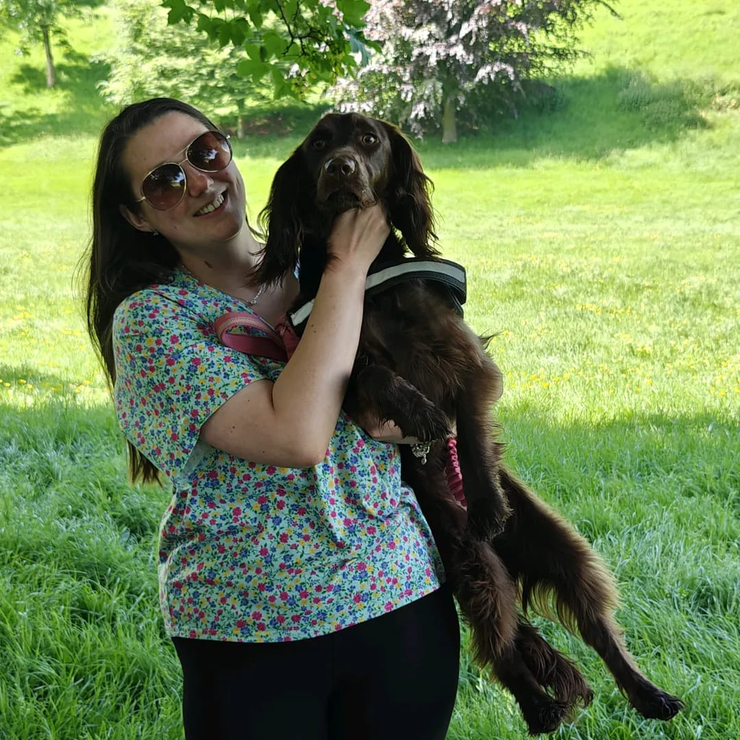 Amy holding a dog outdoors